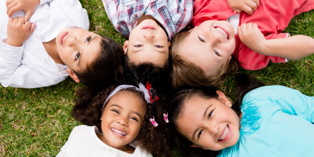 kids sitting in circle in grass